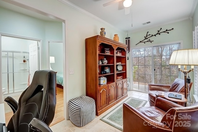 living area with ceiling fan, ornamental molding, and visible vents