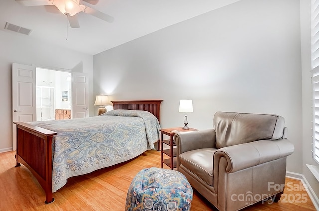 bedroom with light wood finished floors, baseboards, visible vents, ceiling fan, and vaulted ceiling