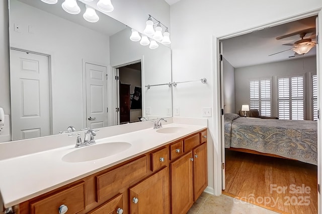 full bathroom featuring connected bathroom, a sink, ceiling fan, and double vanity