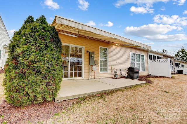 rear view of property with central AC, a lawn, and a patio area