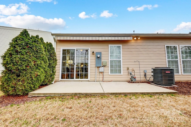 rear view of property featuring central AC and a patio area