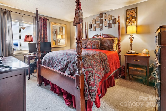 bedroom featuring light carpet and a textured ceiling