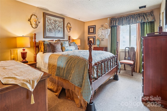 carpeted bedroom featuring a textured ceiling and visible vents