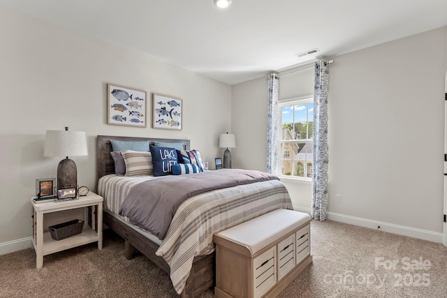 carpeted bedroom featuring baseboards and visible vents