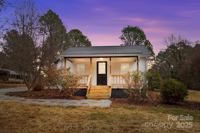 view of front of house with covered porch and metal roof