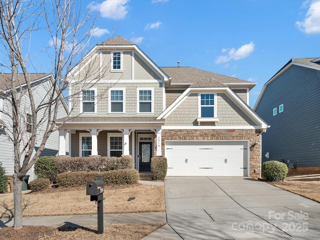 view of front of home with driveway, stone siding, a shingled roof, and a garage