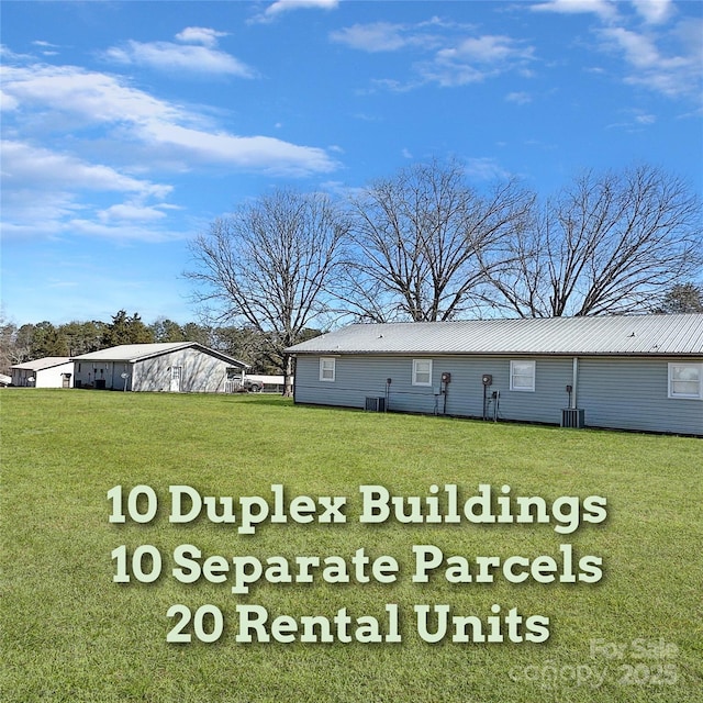 exterior space featuring central air condition unit and a lawn