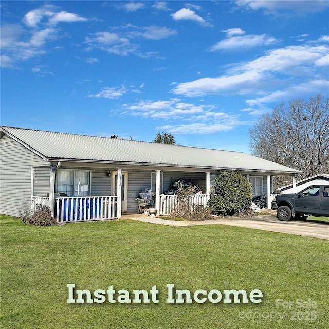 ranch-style house featuring covered porch, metal roof, and a front yard