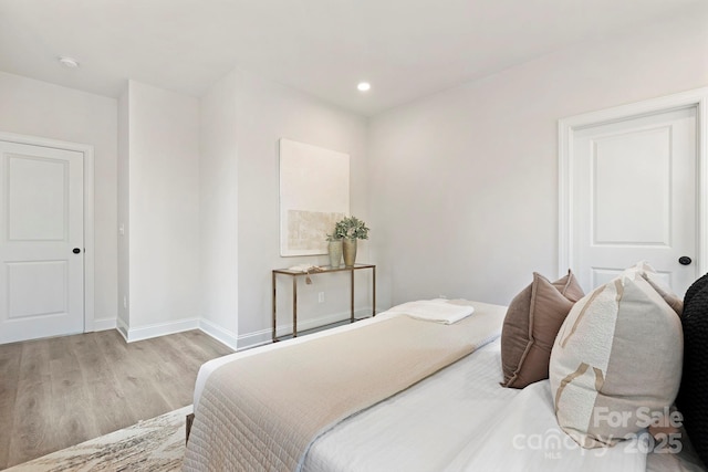 bedroom featuring baseboards, recessed lighting, and light wood-style floors