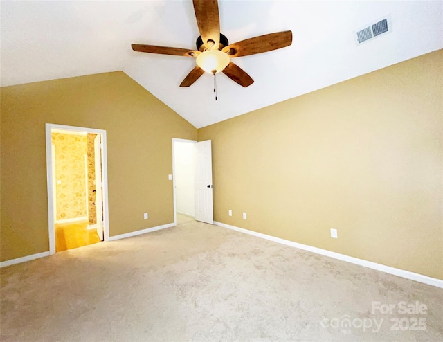 unfurnished bedroom featuring carpet, visible vents, ensuite bathroom, vaulted ceiling, and baseboards