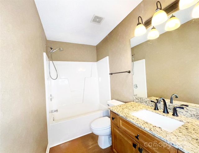 full bathroom featuring bathing tub / shower combination, visible vents, toilet, vanity, and wood finished floors