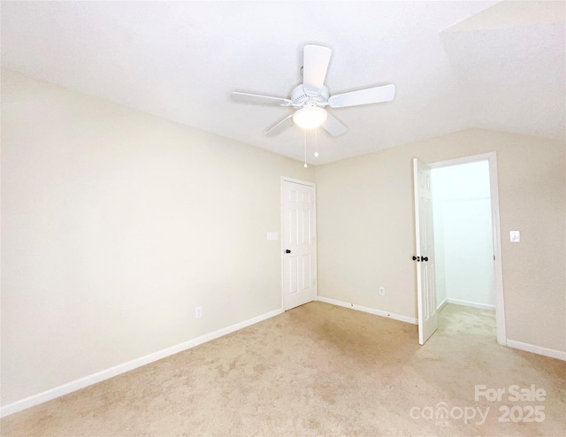 unfurnished room with light carpet, a ceiling fan, and baseboards