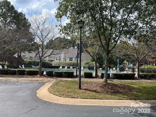 surrounding community featuring fence and a pool