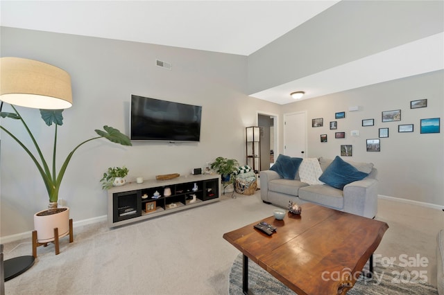 carpeted living room featuring visible vents and baseboards