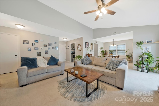 living area with light carpet, ceiling fan with notable chandelier, lofted ceiling, and visible vents