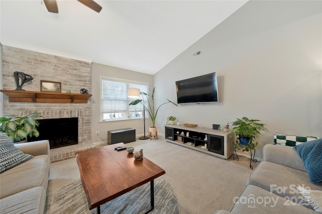 living room with carpet, visible vents, a brick fireplace, ceiling fan, and high vaulted ceiling