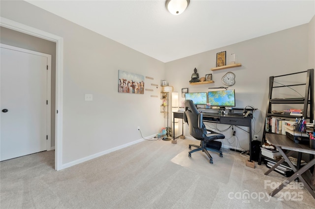 office area featuring light carpet and baseboards