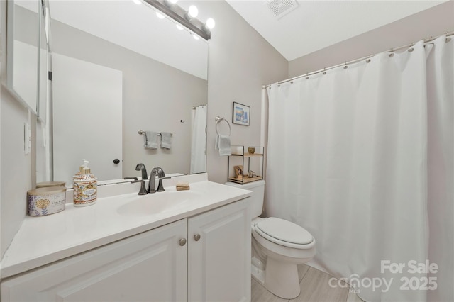 bathroom with visible vents, vanity, and toilet