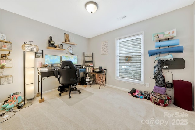 office area featuring light carpet, baseboards, and visible vents