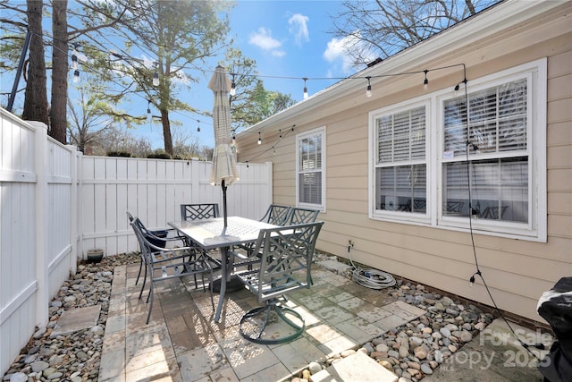 view of patio featuring outdoor dining area and a fenced backyard