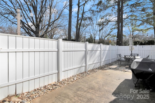 view of patio / terrace featuring outdoor dining area, a fenced backyard, and a grill