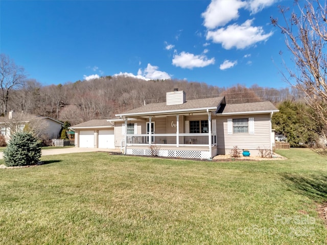 ranch-style house with covered porch, fence, concrete driveway, a front lawn, and a chimney