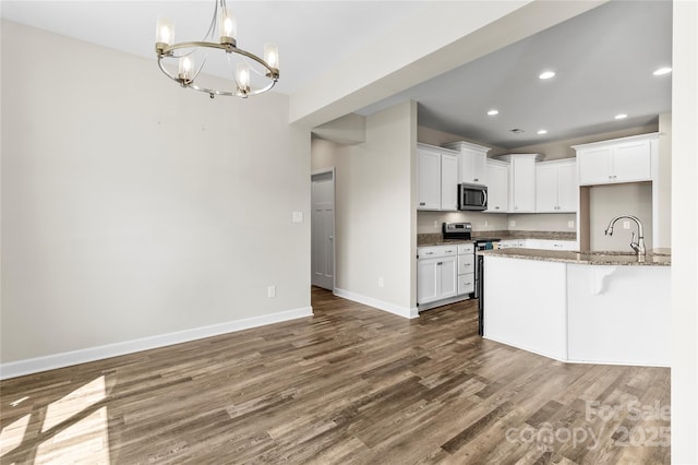 2504 Hovis Rd, Lincolnton, NC 28092 - kitchen featuring stainless steel appliances, dark wood-type flooring, a chandelier, baseboards, and a sink