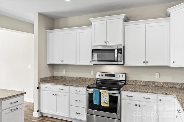 2504 Hovis Rd, Lincolnton, NC 28092 - kitchen with appliances with stainless steel finishes, white cabinetry, wood finished floors, and stone countertops