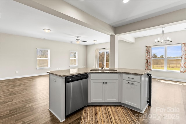 2504 Hovis Rd, Lincolnton, NC 28092 - kitchen with stainless steel dishwasher, a sink, open floor plan, dark wood-type flooring, and light stone countertops