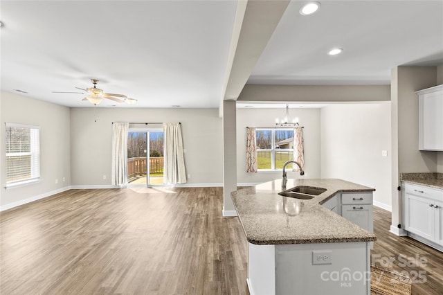 2504 Hovis Rd, Lincolnton, NC 28092 - kitchen with a sink, open floor plan, stone countertops, a ceiling fan, and baseboards