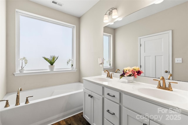 2504 Hovis Rd, Lincolnton, NC 28092 - full bath featuring a garden tub, wood finished floors, and double vanity