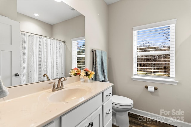 2504 Hovis Rd, Lincolnton, NC 28092 - bathroom with wood finished floors, vanity, baseboards, and toilet
