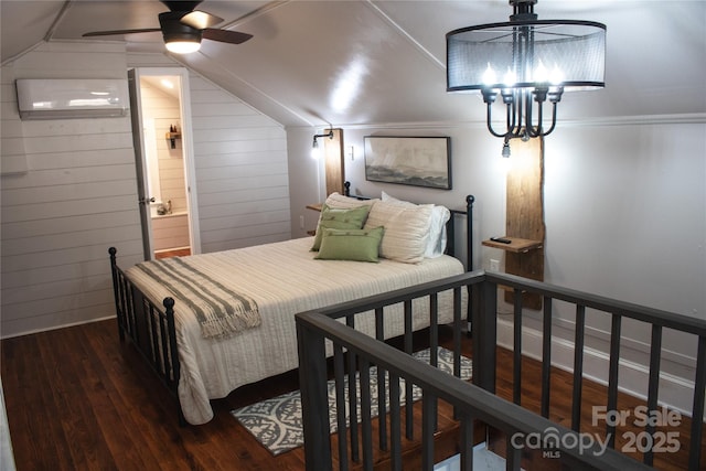 bedroom featuring lofted ceiling, a wall unit AC, a notable chandelier, wooden walls, and wood finished floors