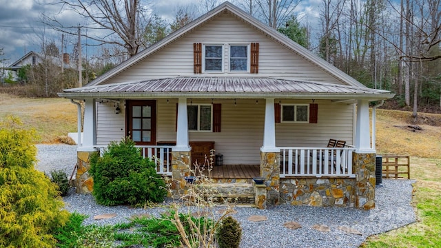 view of front of house featuring covered porch and metal roof