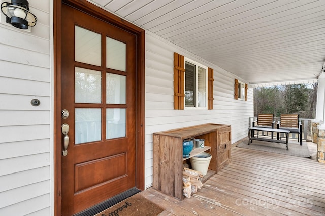 wooden terrace featuring covered porch