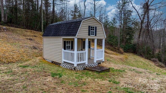 view of outbuilding featuring an outbuilding and a wooded view