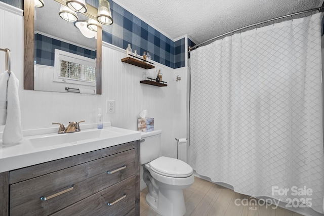 full bath featuring a textured ceiling, toilet, wood finished floors, and vanity