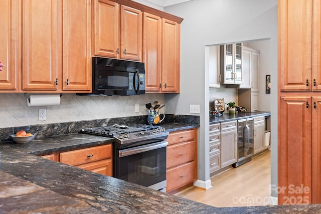 kitchen with brown cabinetry, wine cooler, black microwave, and stainless steel range with gas stovetop