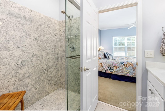 ensuite bathroom featuring a shower with door, ornamental molding, a ceiling fan, vanity, and ensuite bath