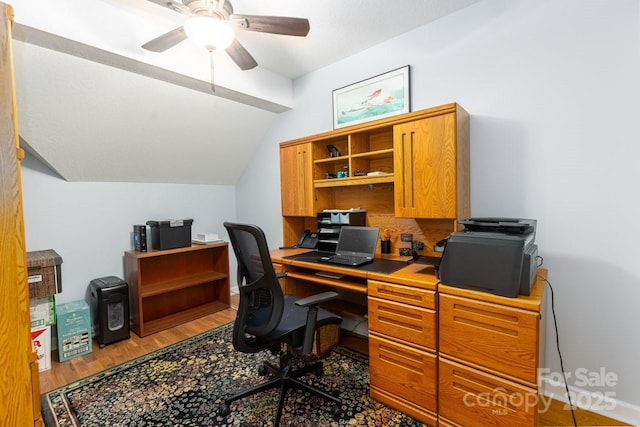 office area featuring lofted ceiling, wood finished floors, and a ceiling fan