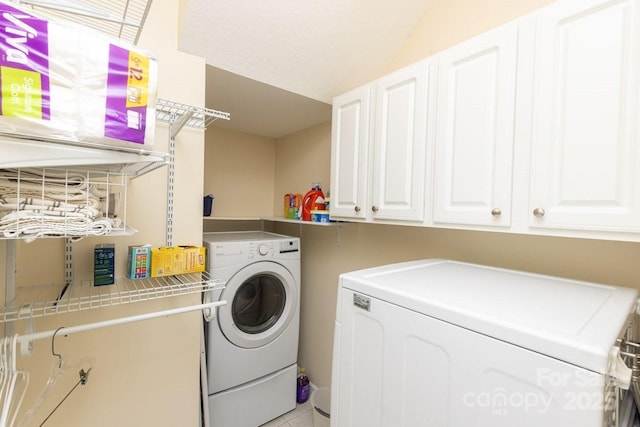 laundry room featuring cabinet space and washer and clothes dryer