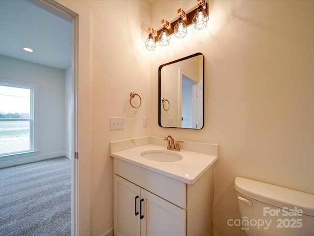 bathroom featuring recessed lighting, vanity, toilet, and baseboards