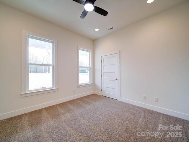 empty room with recessed lighting, visible vents, a ceiling fan, carpet flooring, and baseboards