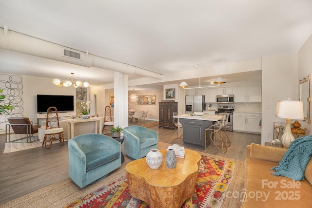 living room featuring light wood-type flooring and visible vents