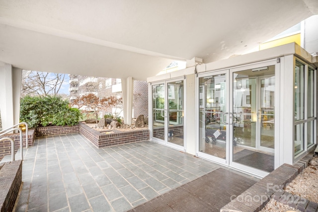 unfurnished sunroom with vaulted ceiling and french doors