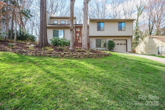 view of front of home with an attached garage, driveway, and a front yard