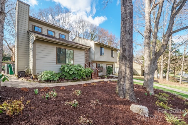 tri-level home with central air condition unit and a chimney