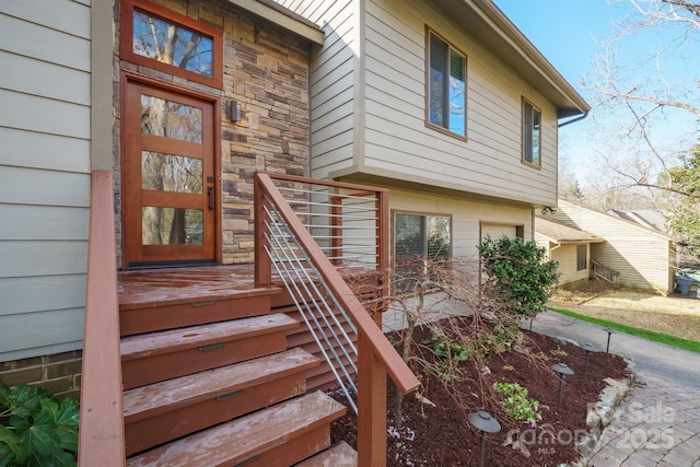 entrance to property featuring stone siding