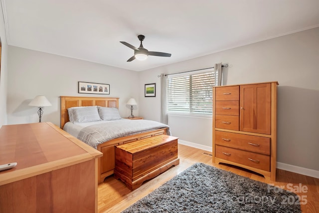 bedroom with light wood-style flooring, baseboards, and ceiling fan