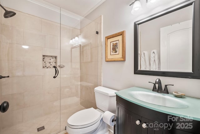 full bath with crown molding, a tile shower, vanity, and toilet